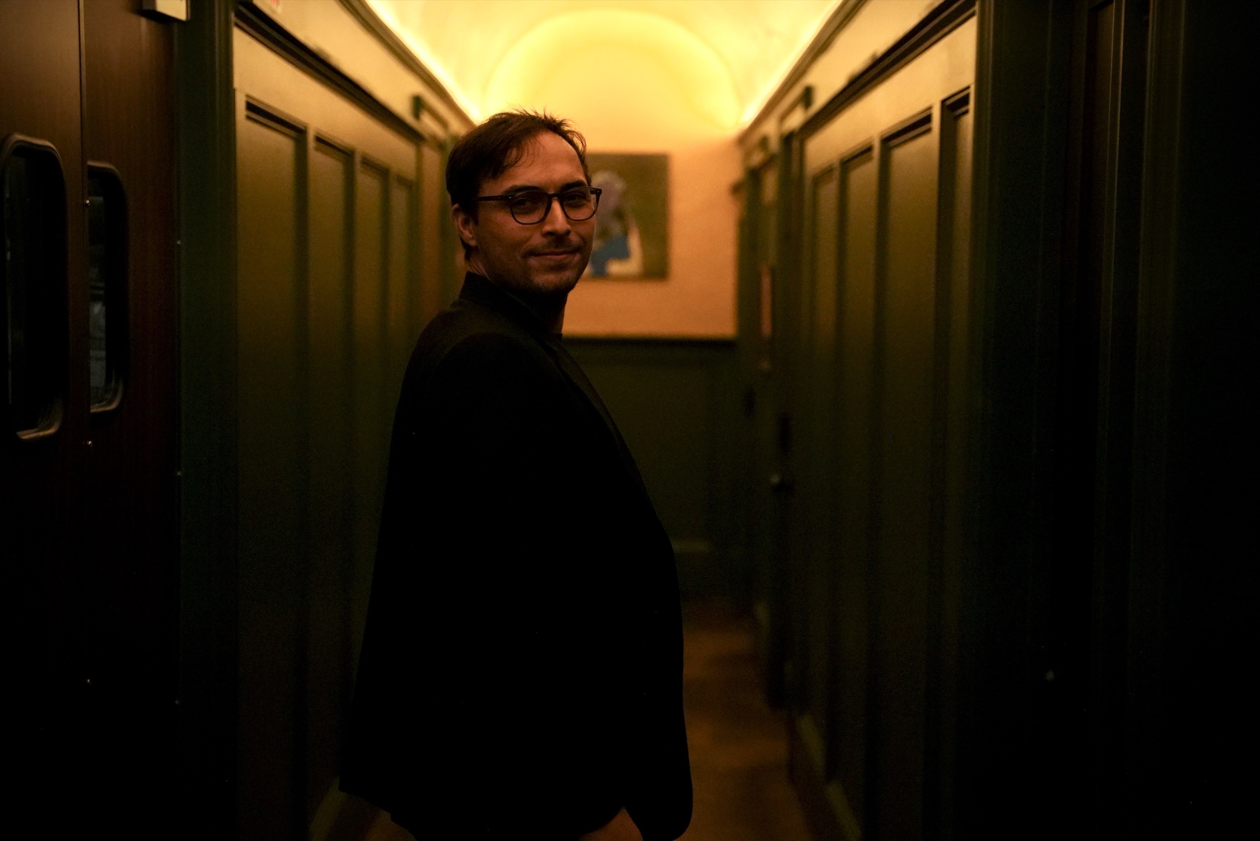 Chase Ellsworth standing in a dim hallway.
